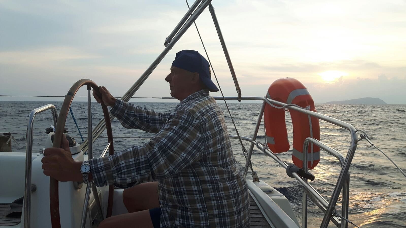 At the helm of the Oceanis 40 at sunset on the Ionian leg At the helm of the Oceanis 40 at sunset on the Ionian leg