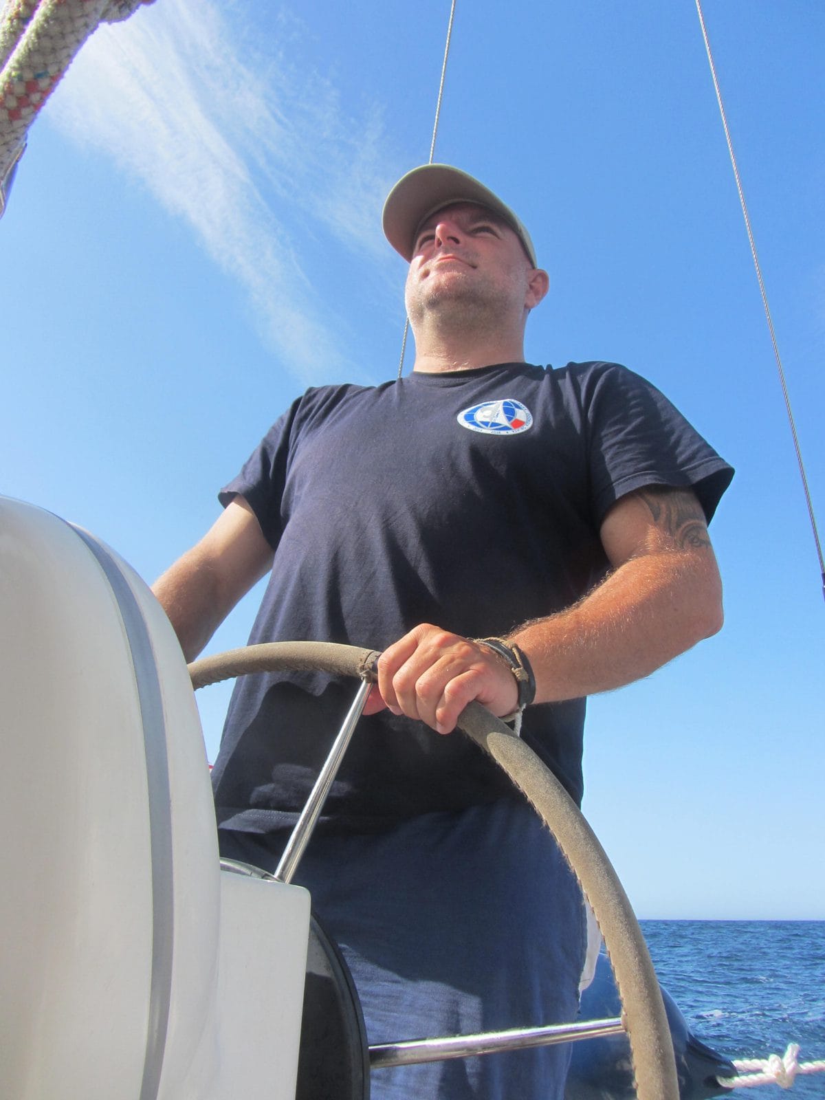 Skipper helming the Bavaria 31 by hand after the autopilot drive failed