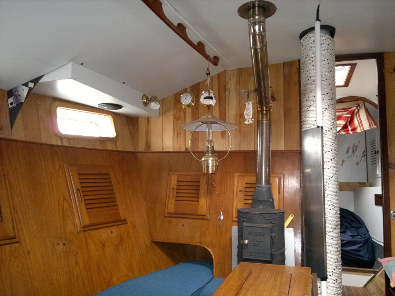 Wooden saloon with a stove on the yacht Fair Grace after her refit in Sweden