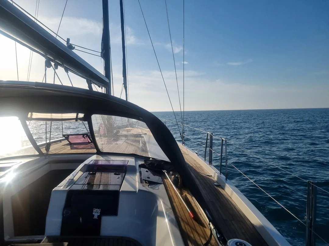 View from the cockpit of a Hanse 575 at sea in the evening, yacht delivery June 2026 View from the cockpit of a Hanse 575 at sea in the evening, yacht delivery June 2026