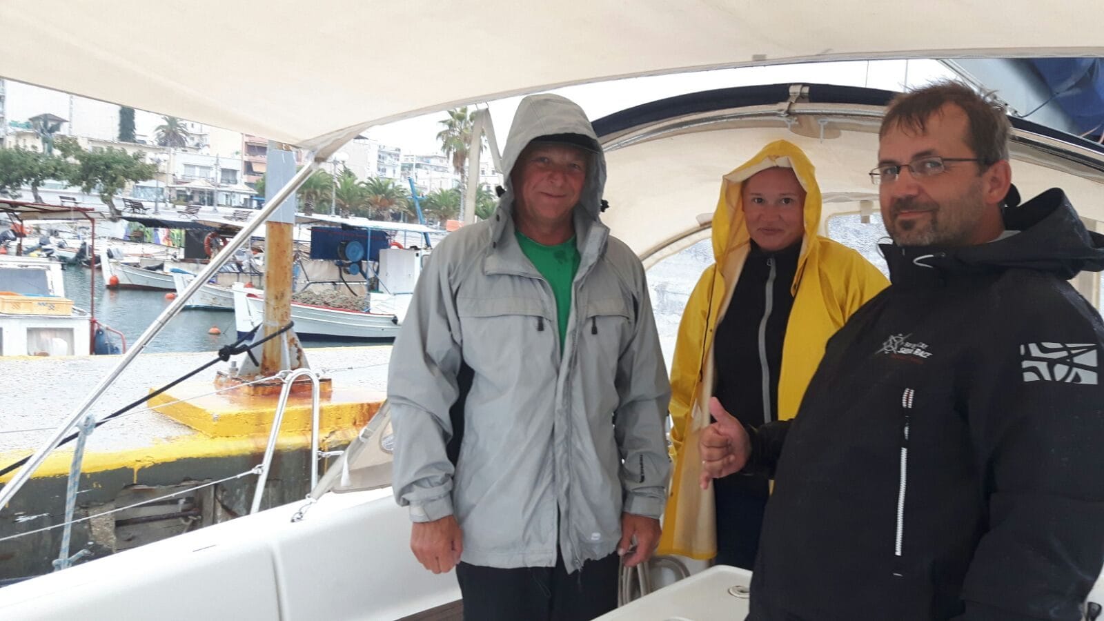 Delivery crew in foul weather gear on arrival of the Oceanis 40 in Greece