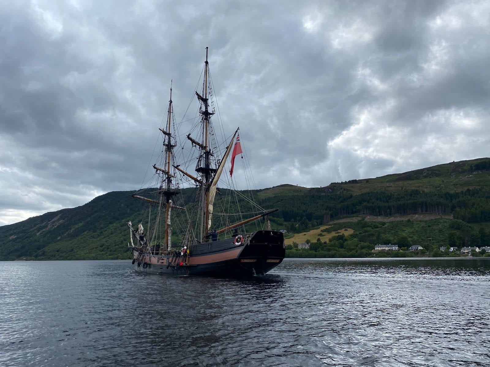 Tall ship Phoenix motoring across a Scottish loch on the Caledonian Canal