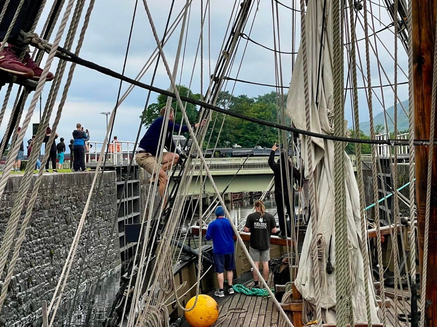 Delivery crew handling the lines on tall ship Phoenix in a Caledonian Canal lock